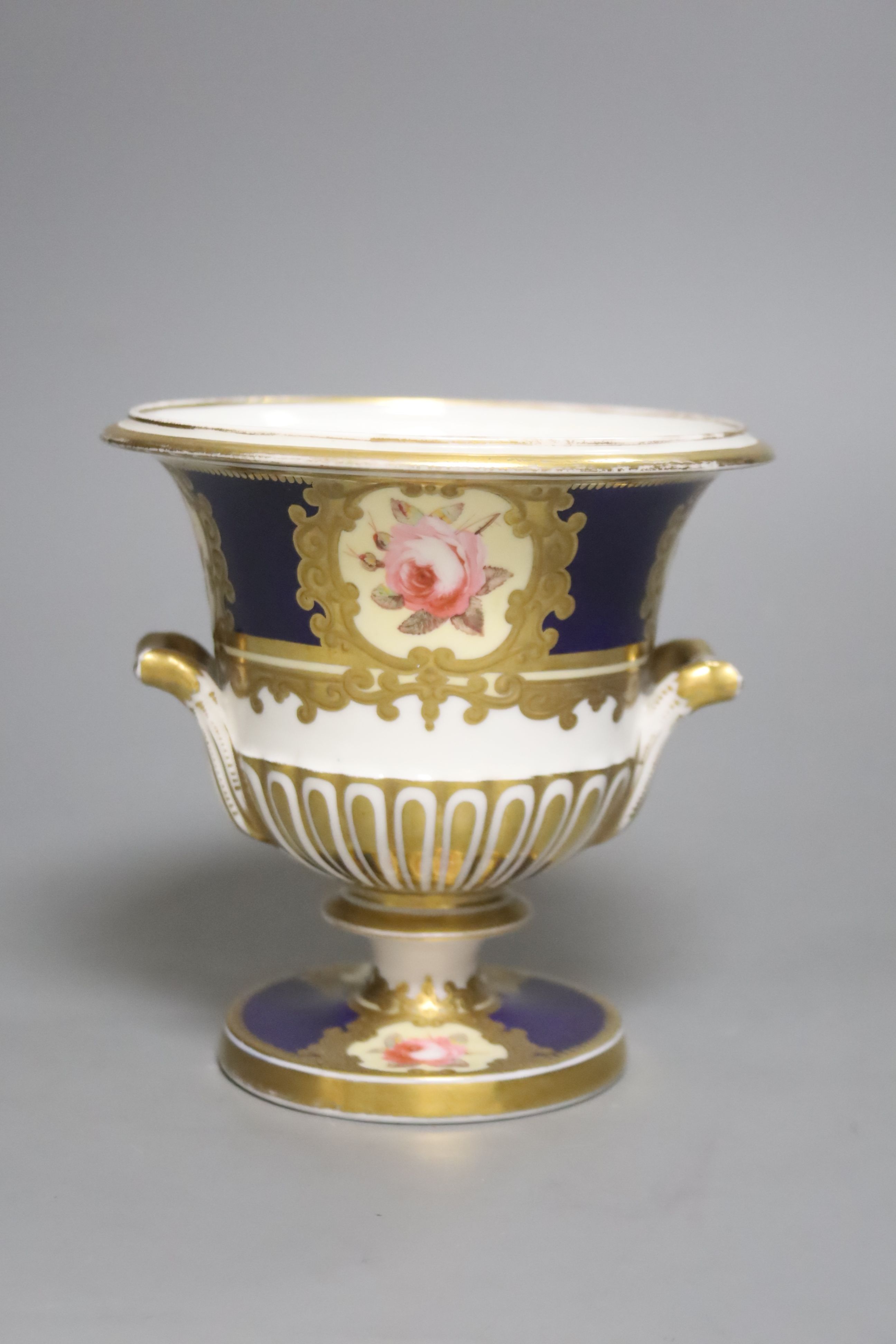 A Chamberlains Worcester two handled vase, painted with six single roses on a blue ground, height 14.5cm